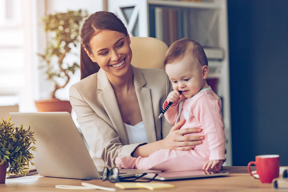 mum-with-baby-trying-to-work-on-online-business-on-laptop.jpg