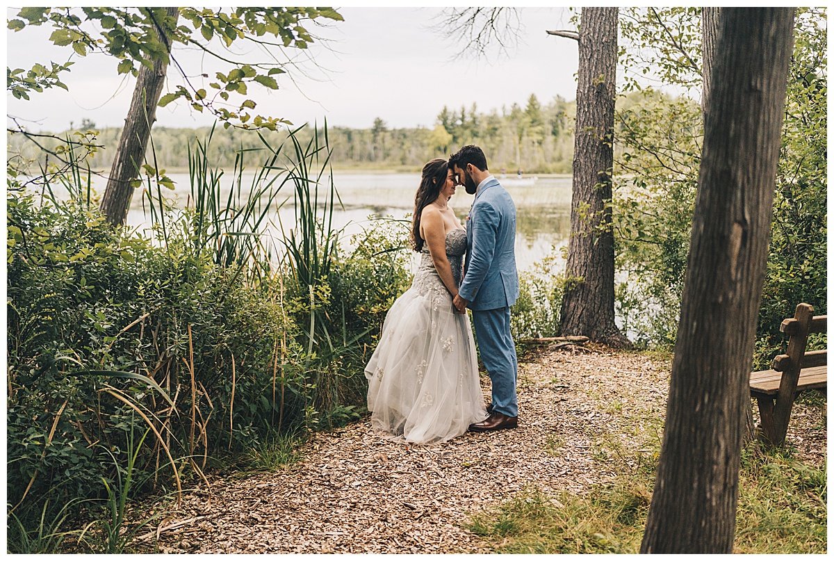 Couple standing in front of lake at venue