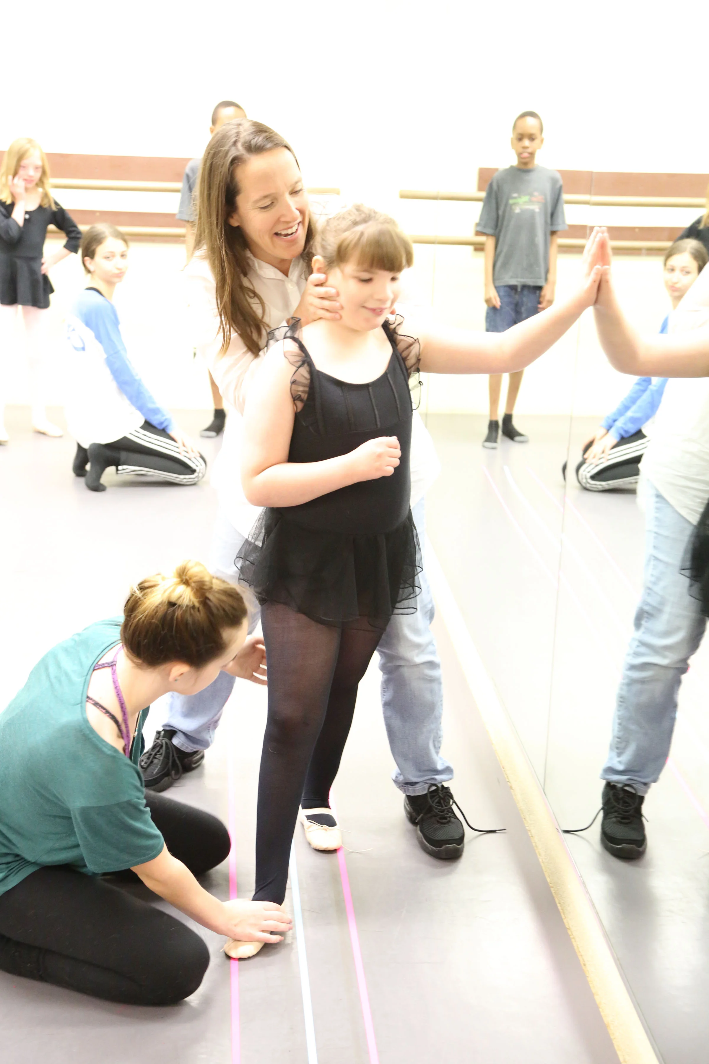 Students learning ballet walk and proper turnout.