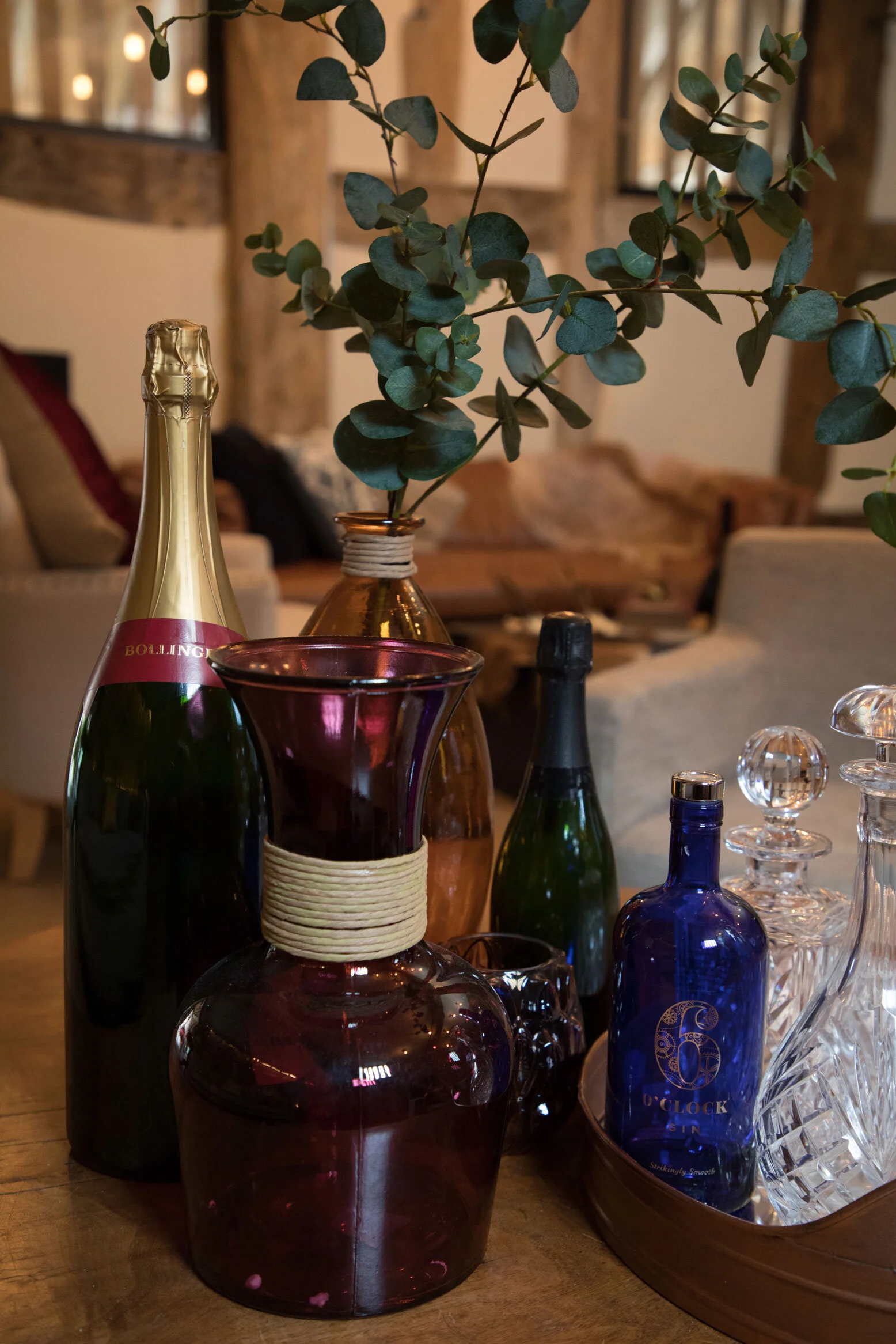 Editorial shot of crystal and glass decanters and champagne bottles