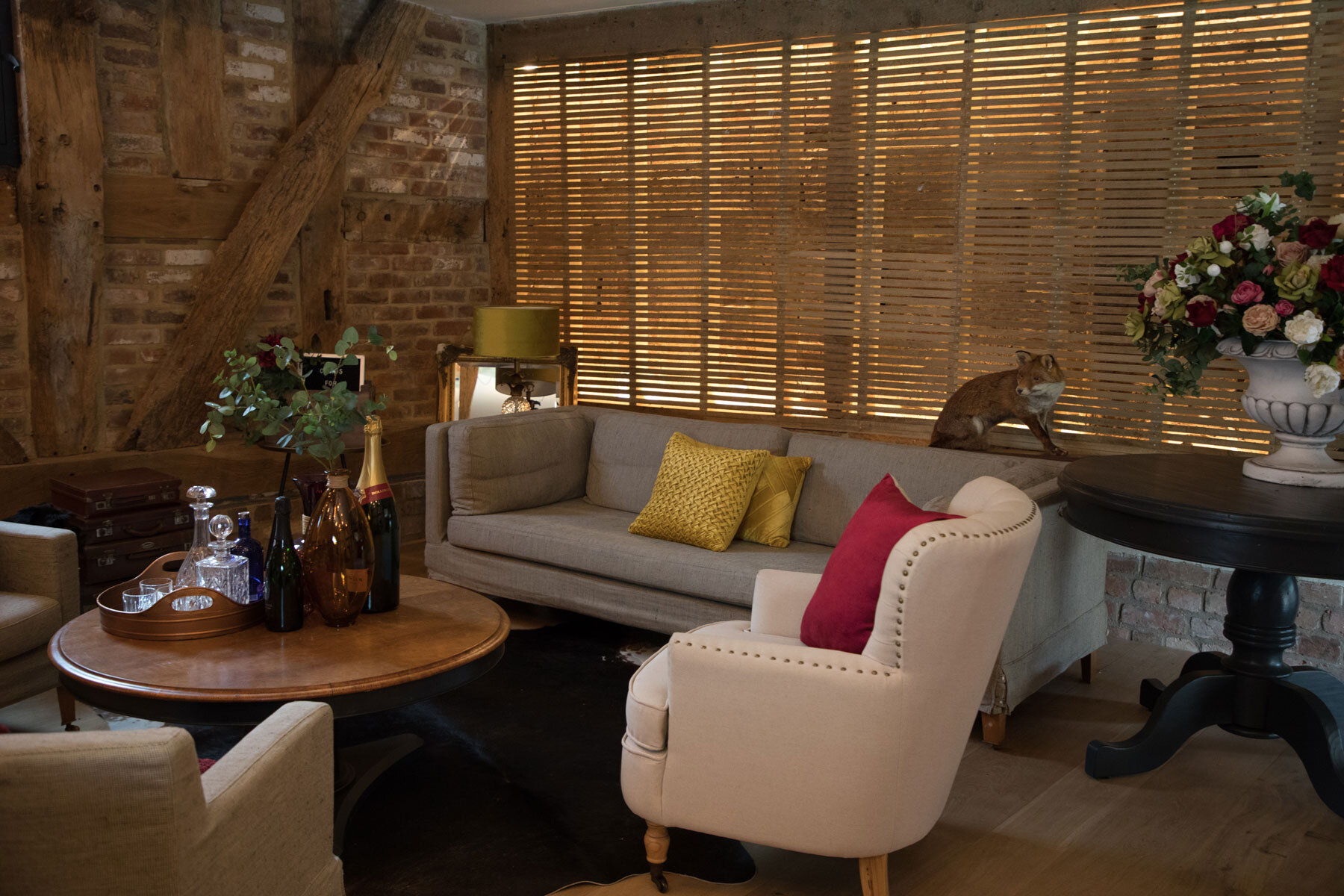 Bare lath and plaster wall being the backdrop to a cosy sitting area