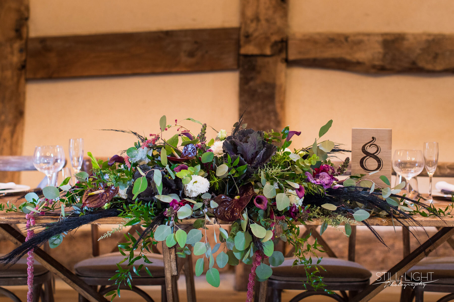 Deep purple and green foliage elaborate table centre peice