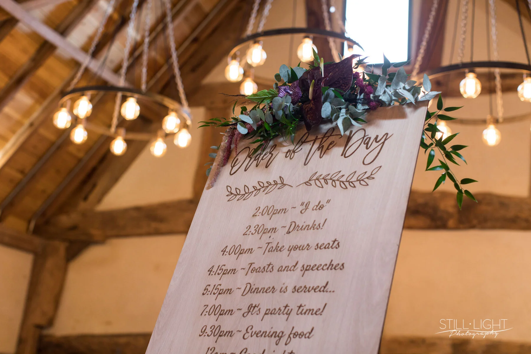 Close-up of handcrafted wedding order of the day decorated  with silk ribbon and botanical styling