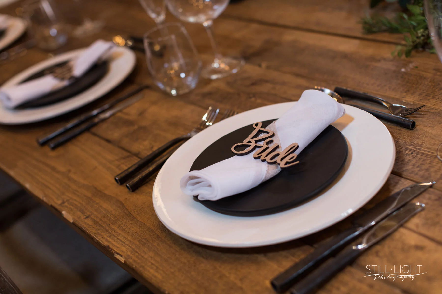 uxury place setting with stoneware plates, crystal glassware and textured linen napkin