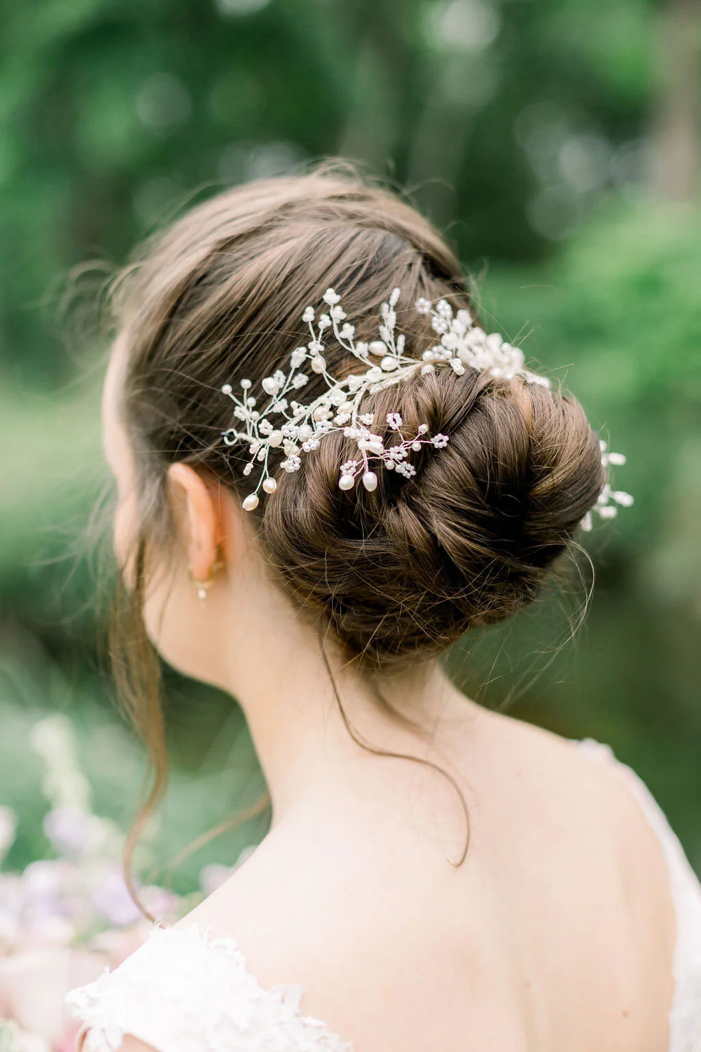 Close up of the bride's hair piece, wired floral piece adored with perals