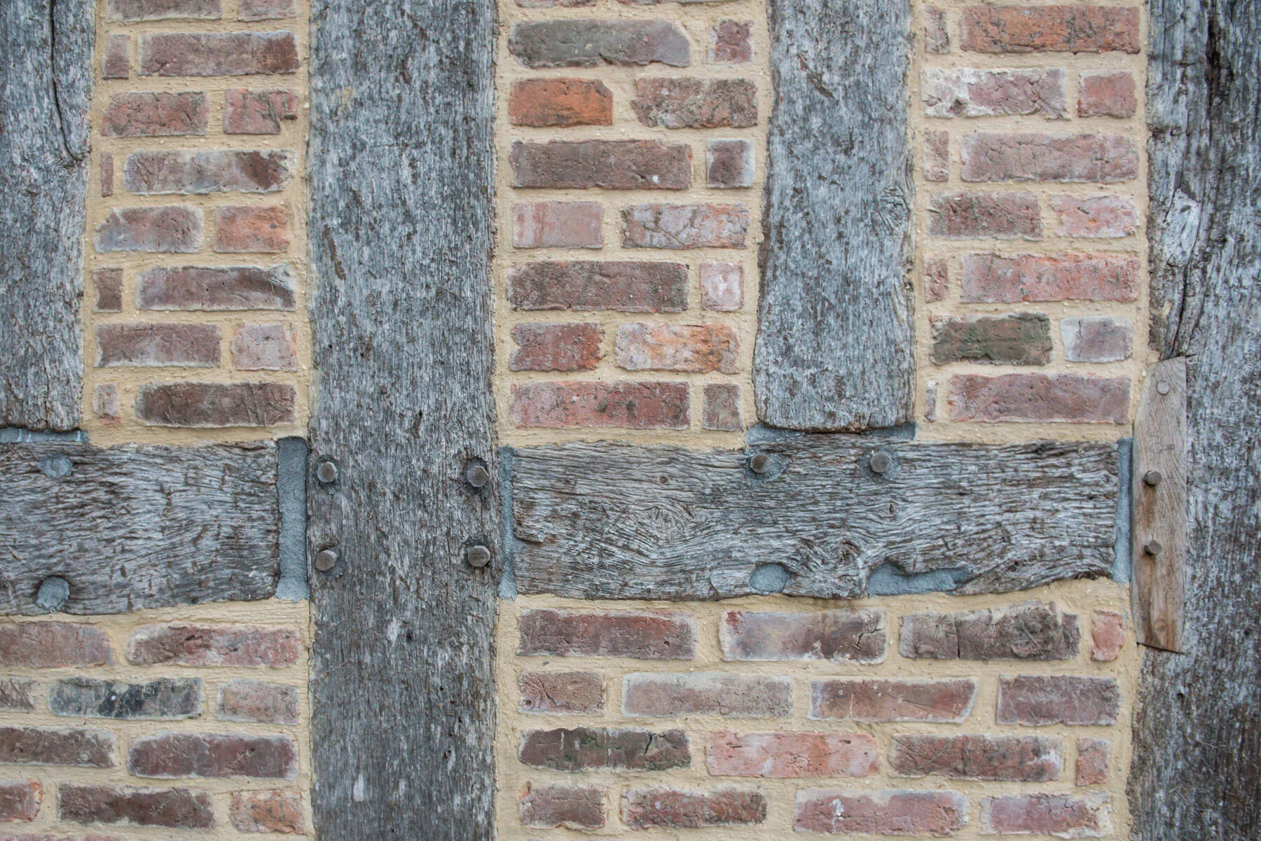Front on close up of brickwork and timbers of the barns