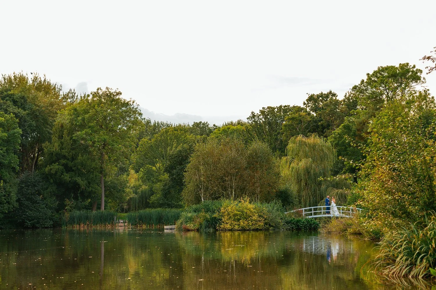 Barns and Yard Wedding Venue Lakeside Couple on Bridge.jpeg