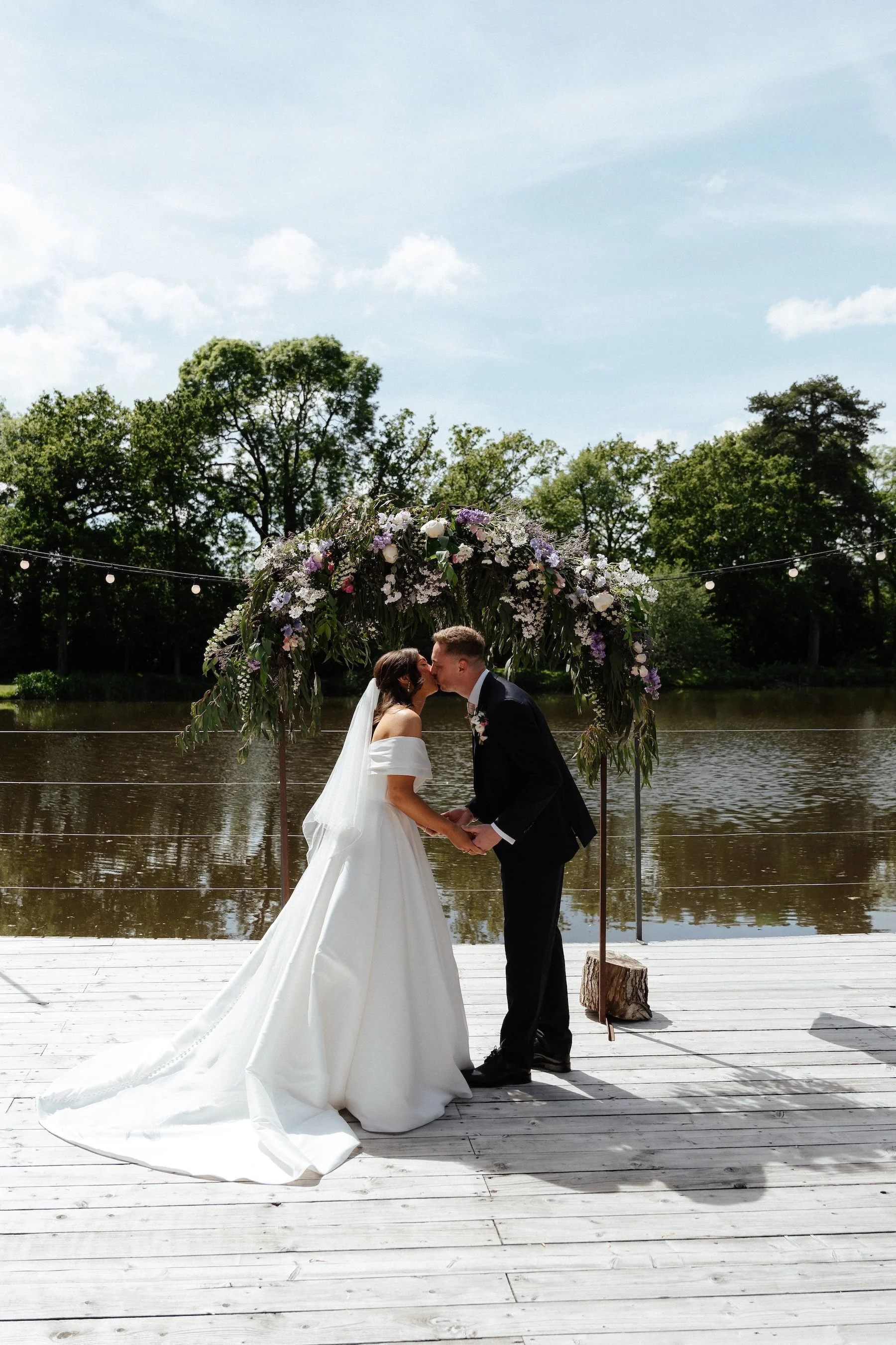 GraceDoveFirst Kiss Beneath the Floral Arch.jpg