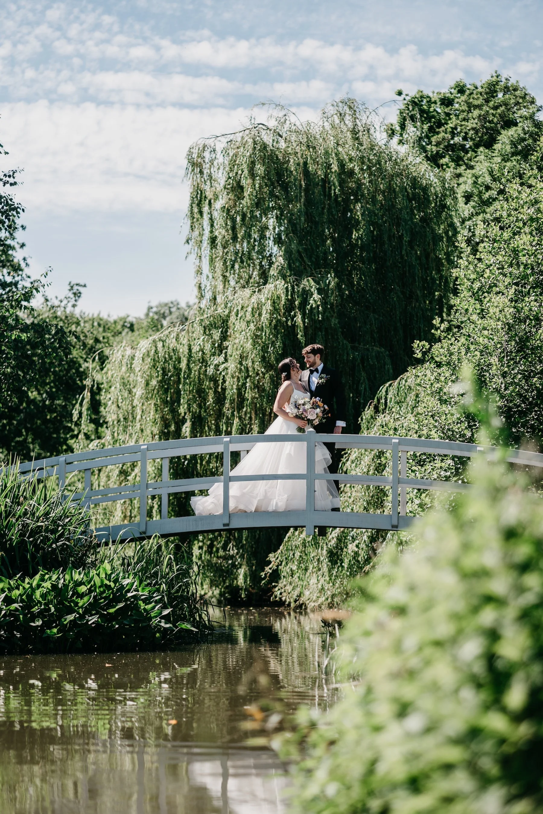 AllieTomWeddingonthebridegeatbarnsandyard.jpg