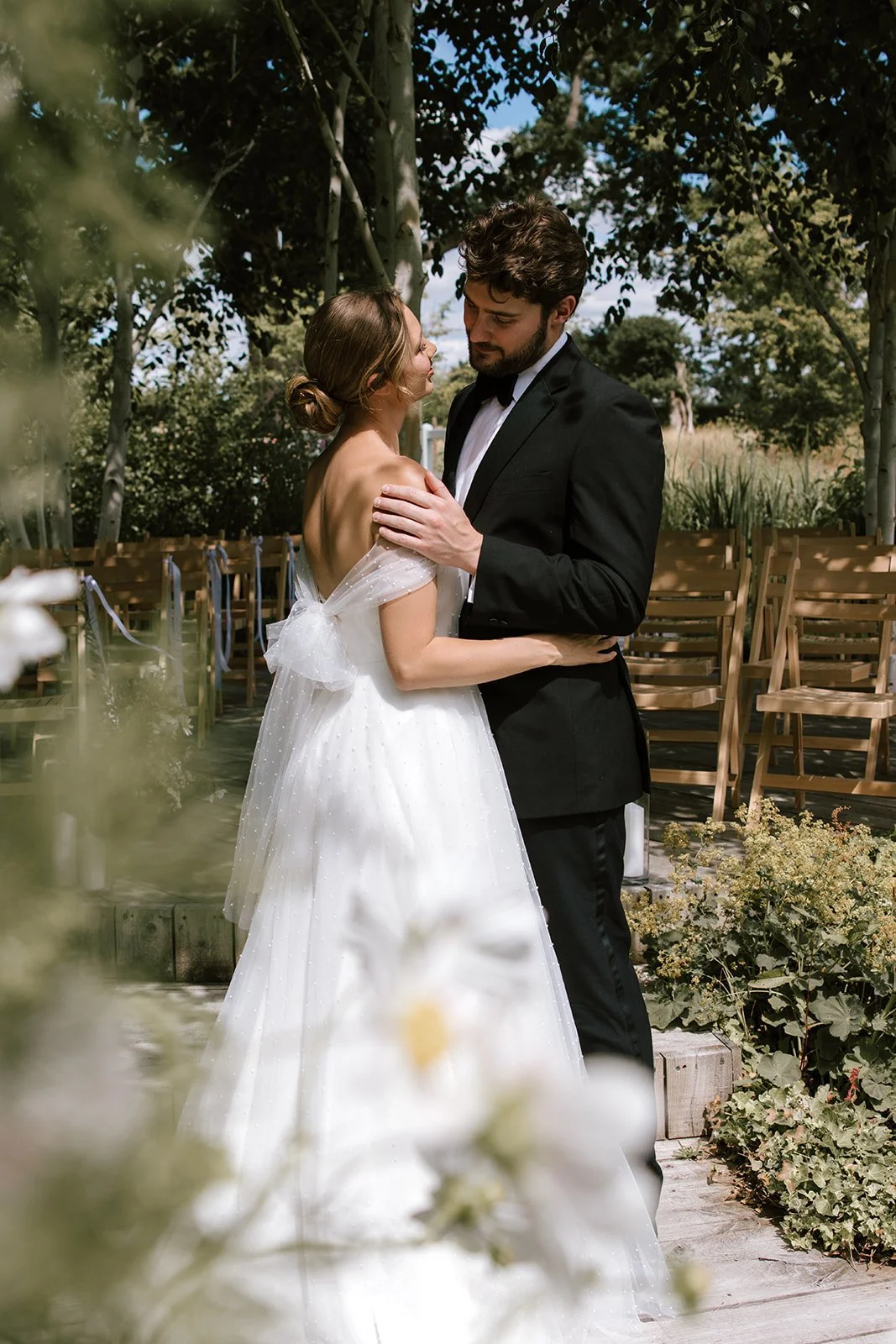 Couple sharing a romantic moment beside the lake at Barns & Yard