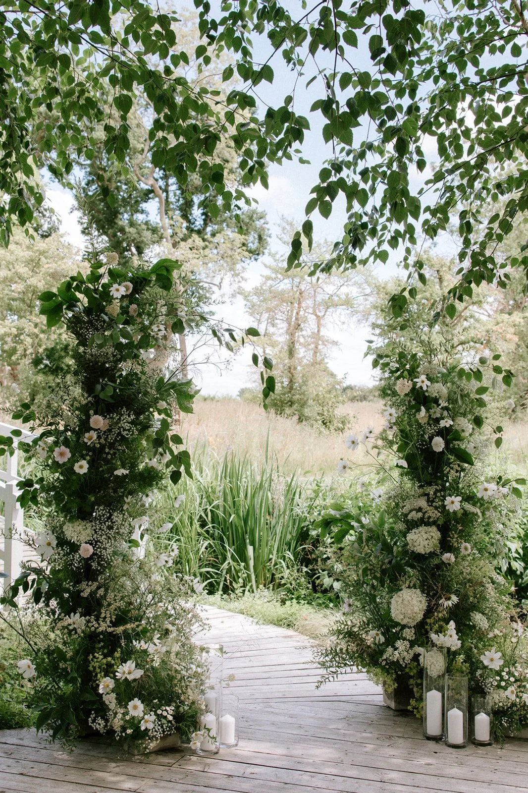 Floral arch of ivory and cream garden flowers with natural greenery