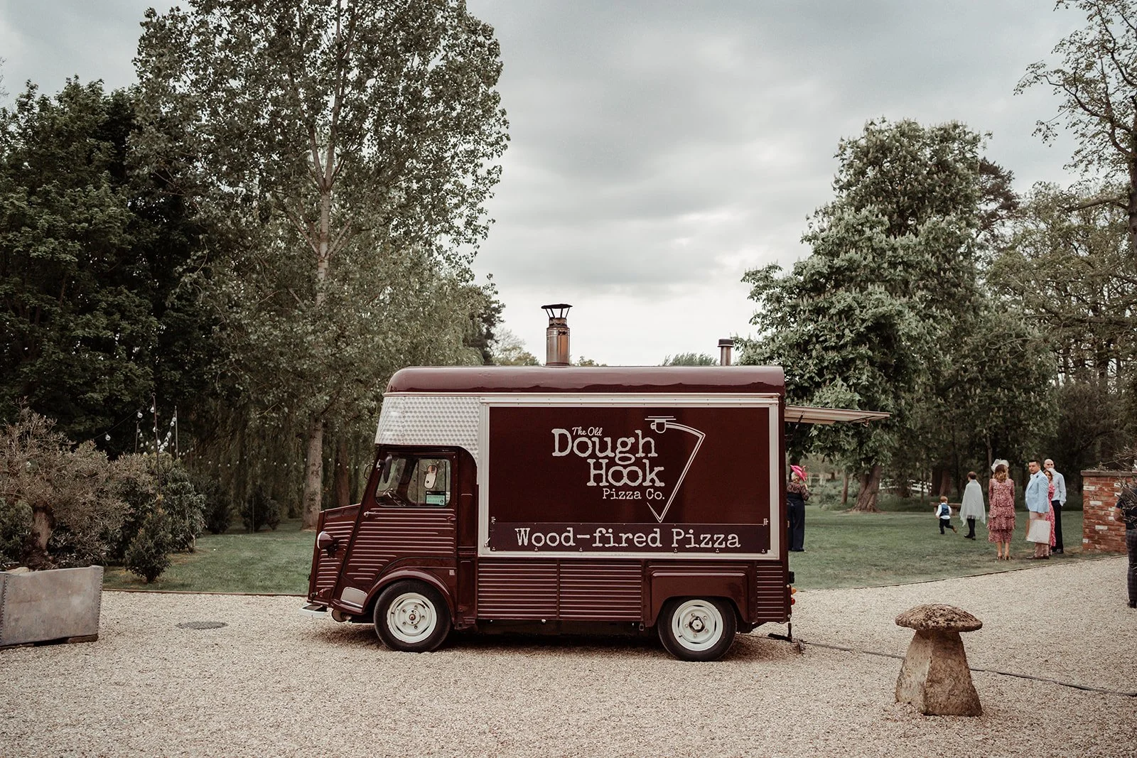 Restored Citroën H van converted into a mobile pizza kitchen serving freshly cooked pizzas at a wedding.