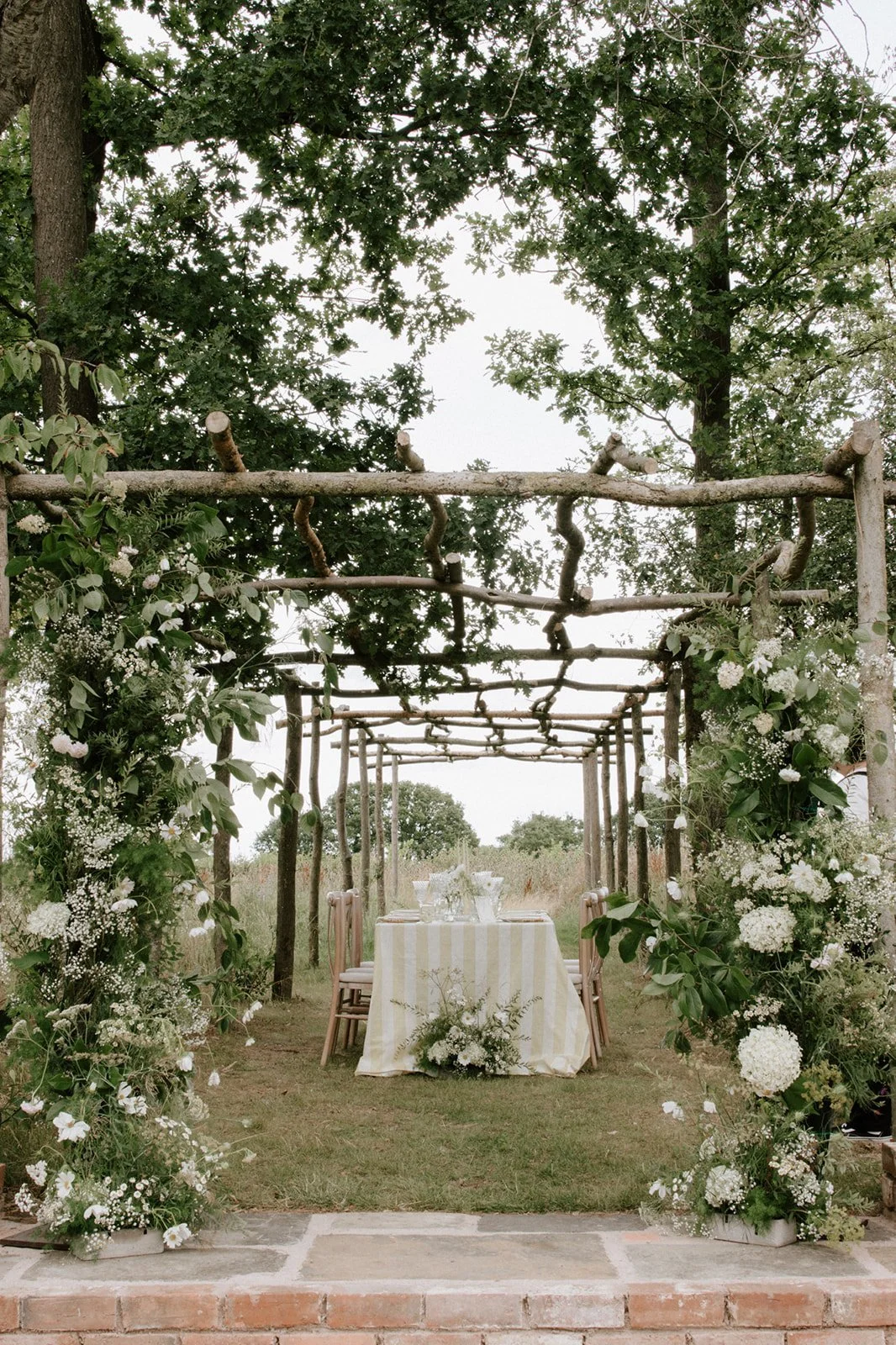 Elegant wedding tablescape with ivory linens, candles and seasonal flowers