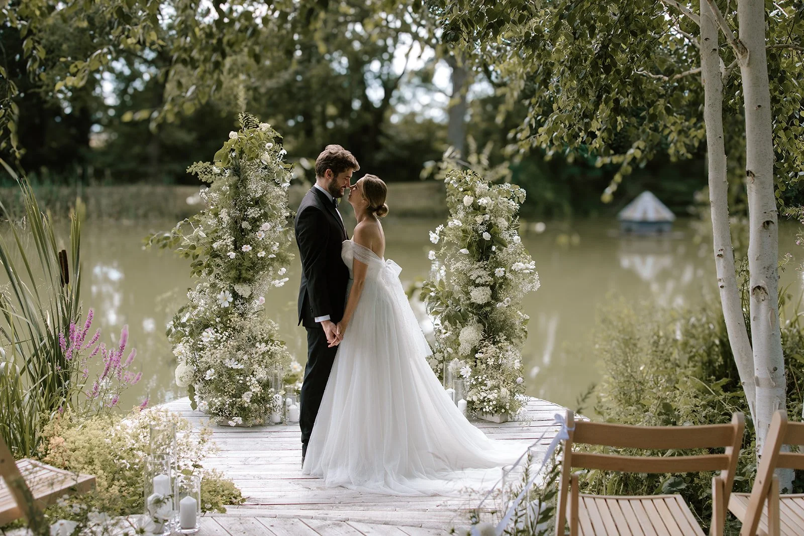 Couple sharing a romantic moment beside the lake at Barns & Yard