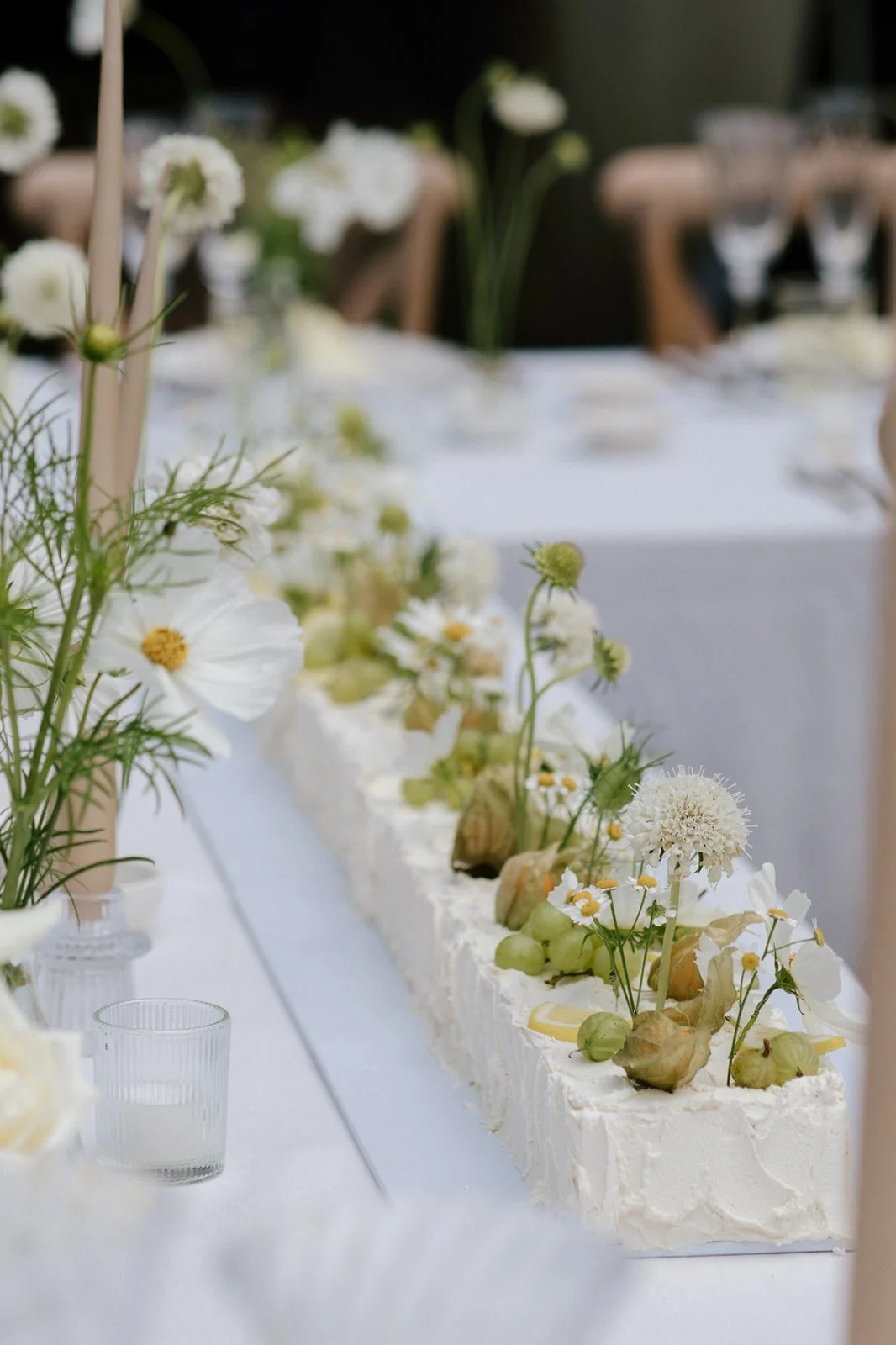 Romantic summer wedding styling with ivory florals, flowing drapery and candlelight at Barns & Yard