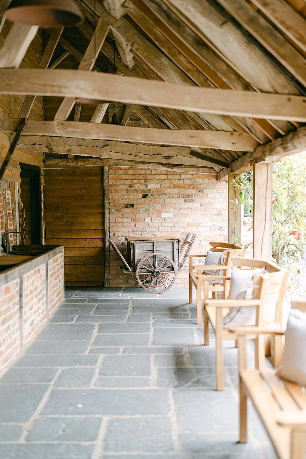 Covered outdoor terrace and seating area at Barns & Yard luxury wedding venue in Worcestershire