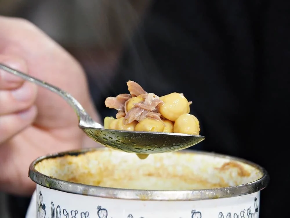 close up of a spoon of piti, a traditional Kars dish of chickpeas and stewed meat