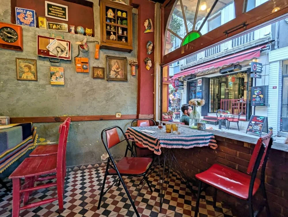The brightly decorated interior filled with vintage items and antiques at Cafe Naftalin in Balat Istanbul