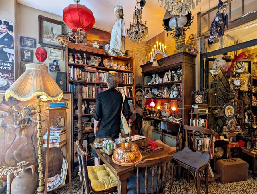 A man looks at books on a bookshelf at Nu Antik Cafe and Rare Books in Istanbul