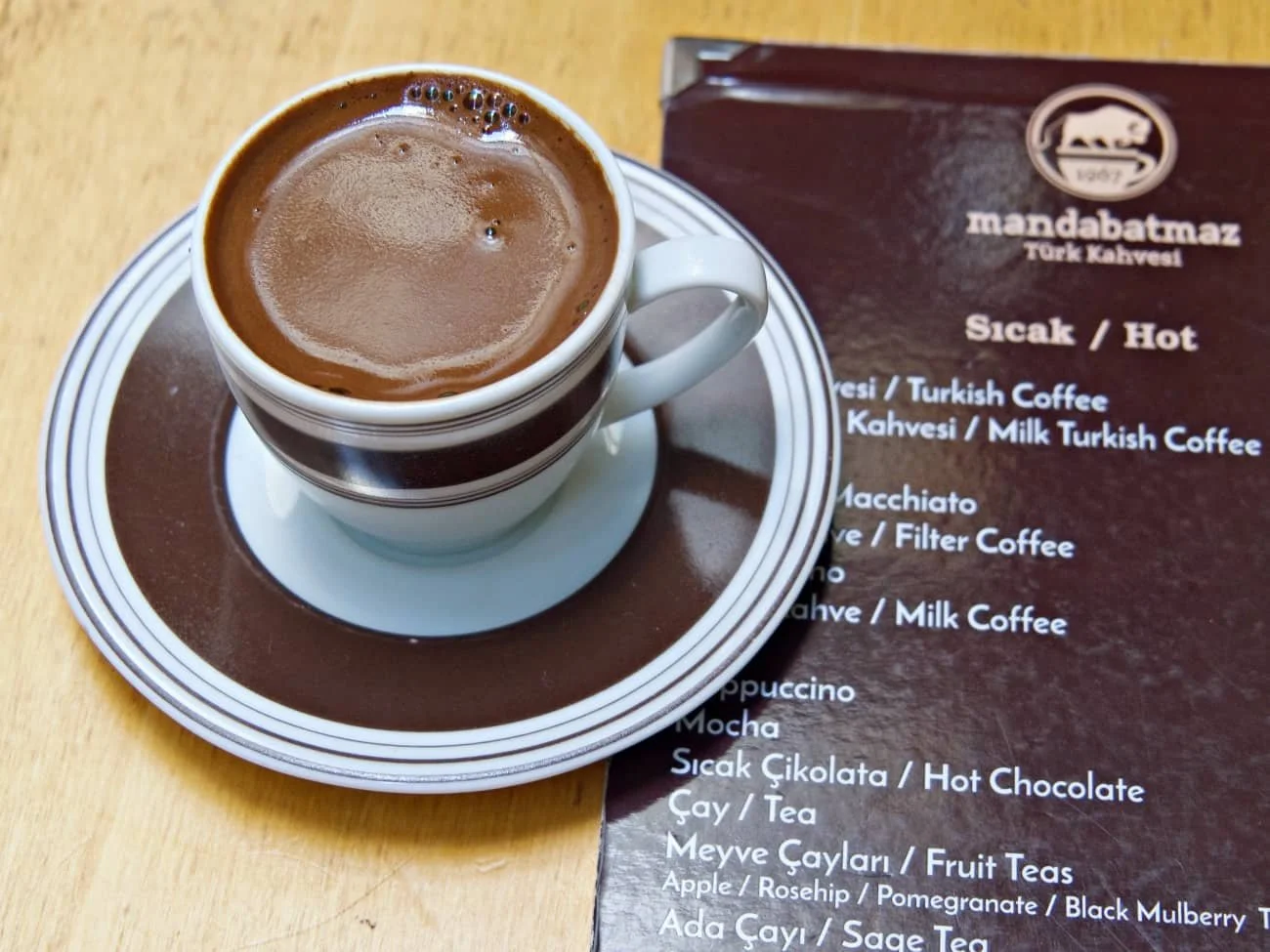 Turkish coffee at Mandabatmaz in Istanbul , close up of Turkish coffee cup on top of the Mandabatmaz menu