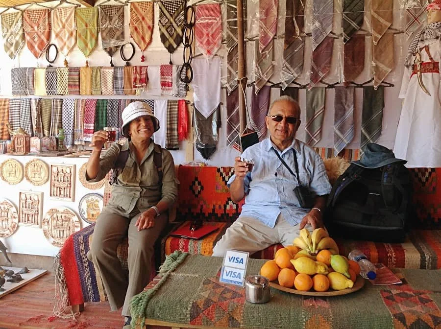 Sasha's parents hold up lemon mint tea at a cafe in Petra Jordan