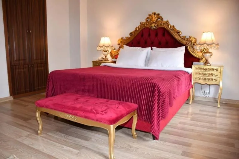 Photo of a bed with gold decoration at Katerina Palace 1877 hotel, kars turkey hotels