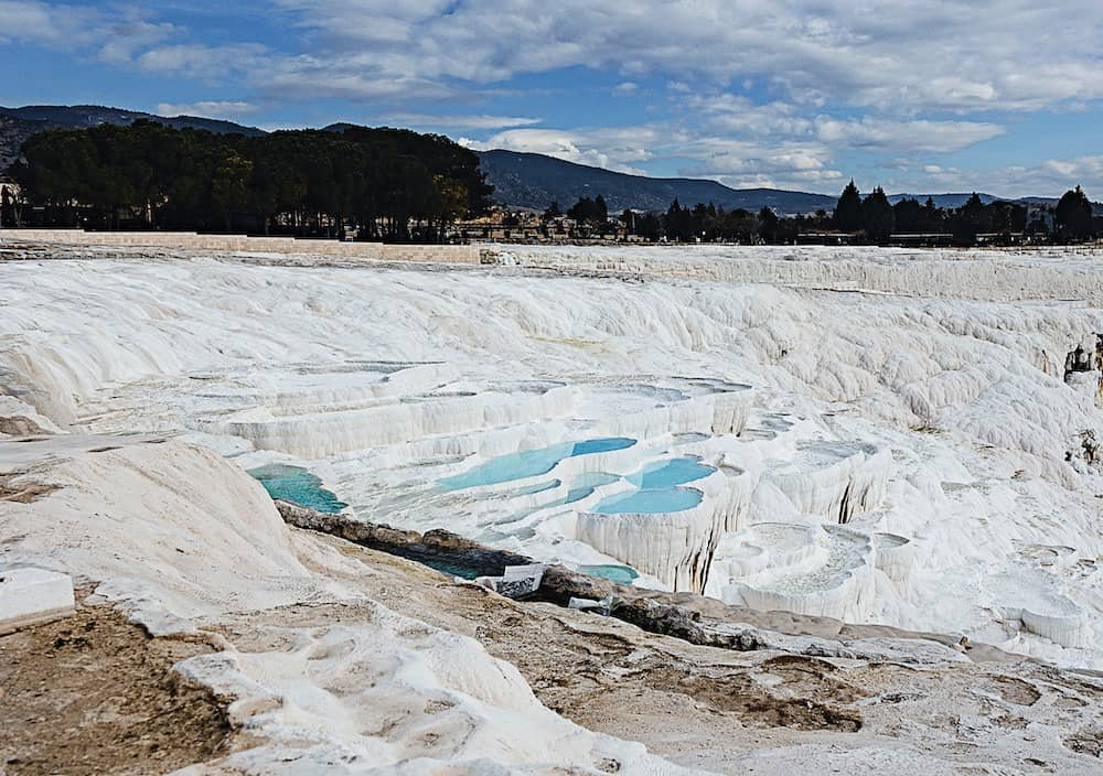 14 day travel itinerary turkey The blinding white rocks and terraced pools at Pamukkale thermal pools in TĂŒrkiye. Some of the pools are filled with water whilst others are dry.