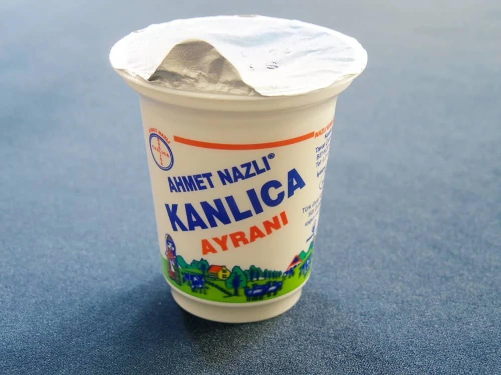 Close up of  a pot of Ahmet Nazli Kanlica Ayran on a table