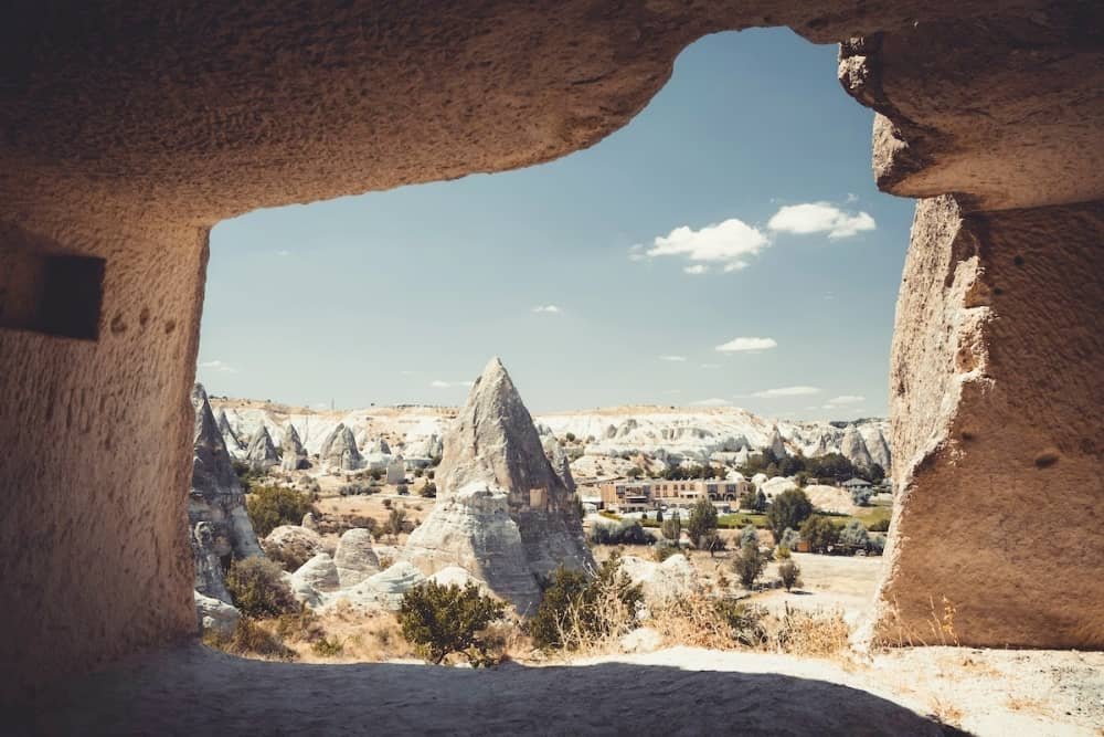 14 day travel itinerary turkey Fairy chimneys photographed through a cave entrance in Cappadocia in TĂŒrkiye