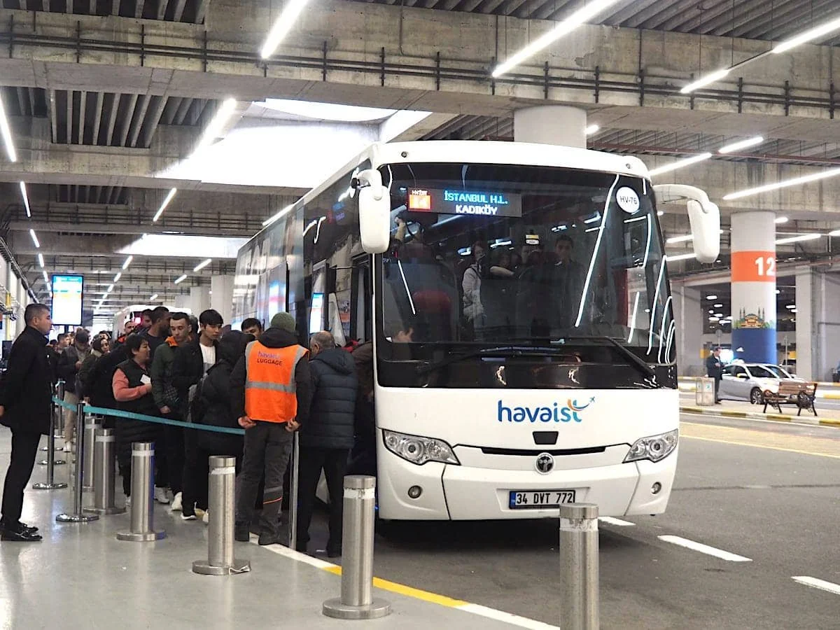 People queue to board a Havaist shuttle bus at Istanbul Airport