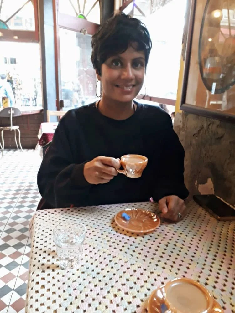 Sasha drinks a cup of Mardin coffee at Cafe Naftalin in Balat in Istanbul