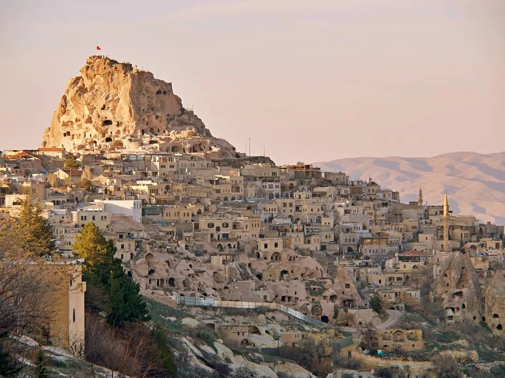 uchisar rock castle towers over the cave and stone houses of Uchisar, best places to stay in cappadocia turkey
