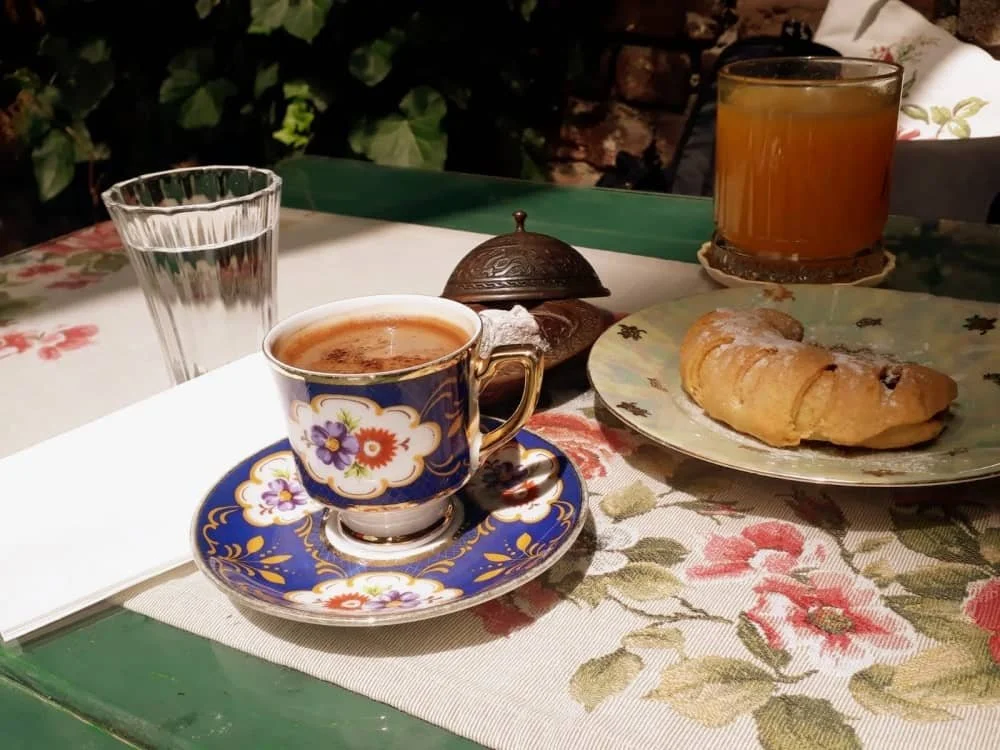 turkish coffee at velvet cafe with a biscuit and an orange juice