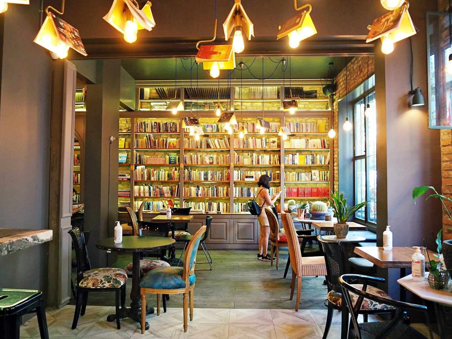 A woman looking at books in a beautiful bookshop