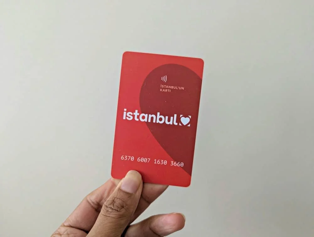 A hand holding up the red istanbulkart