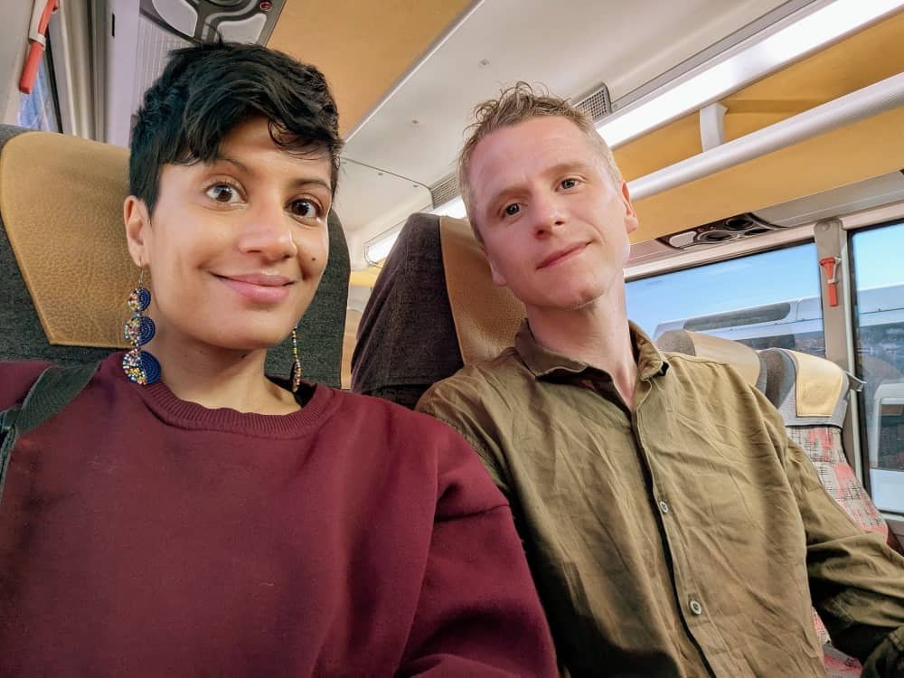 A girl in a maroon jumper and a man in a green shirt on a bus in Cappadocia
