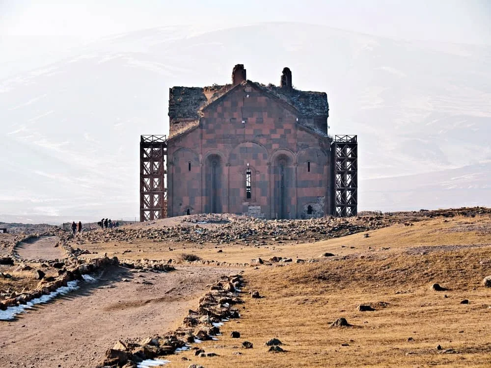 The huge cathedral of Ani in the distance with mountains behind, kars turkey tourism