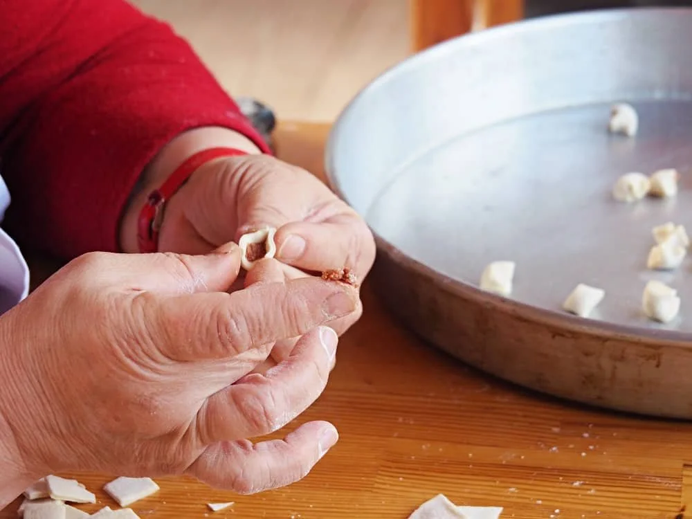 Close up of hands making manti in Turkey