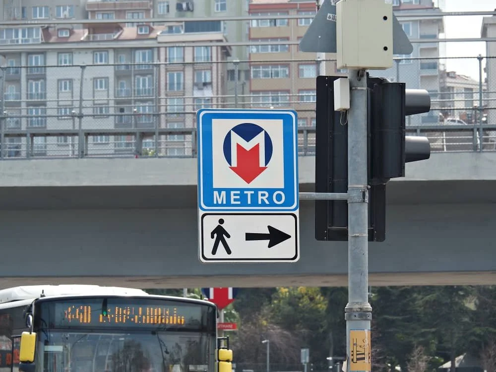 A close up of a red and blue 'M' metro sign in Istanbul