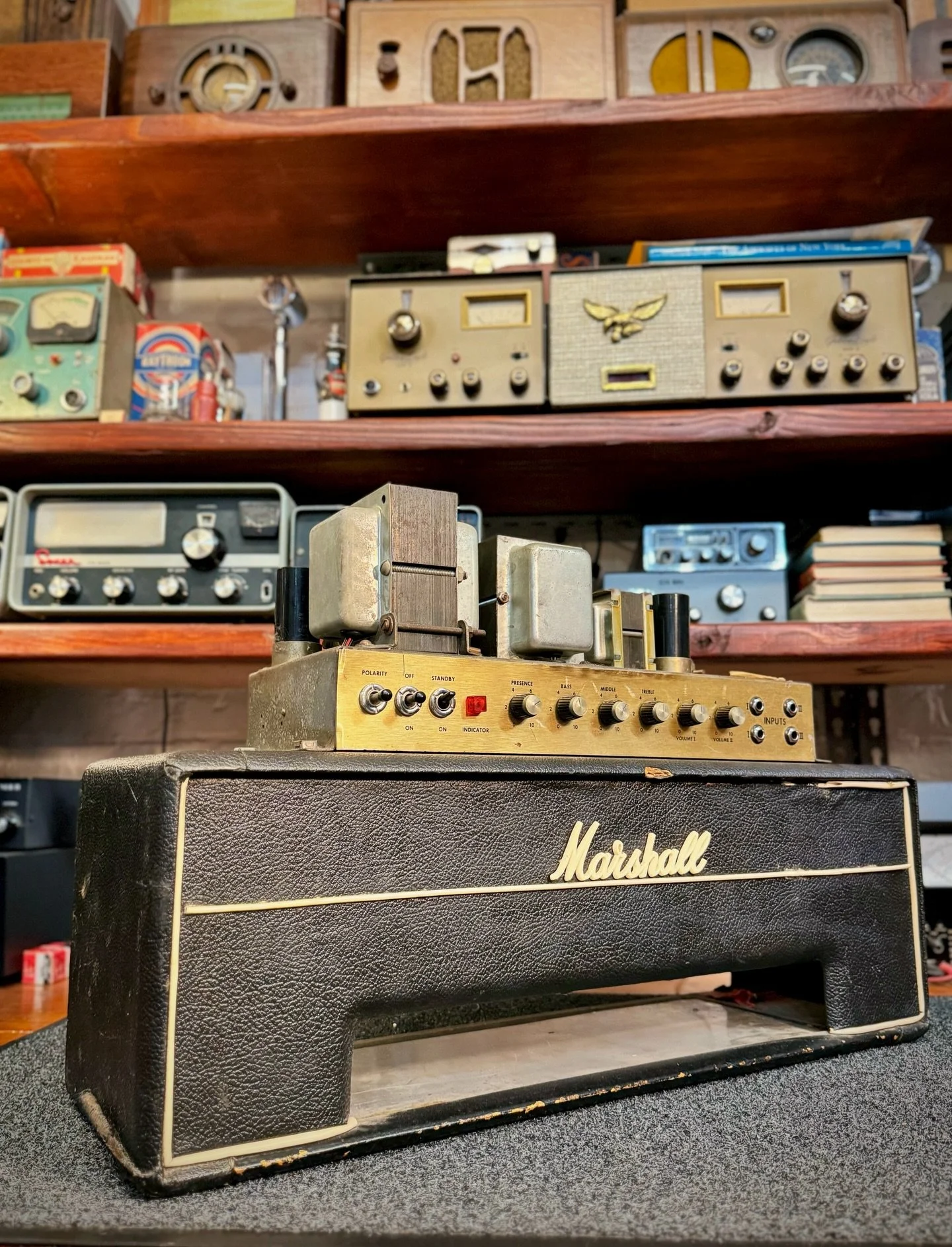 Ageless and iconic! On the bench is an early 1970 JMP 50W head. This Marshall has the period correct small box Levant tolex cab and singing drake transformers. YES Transformers can sing! This front panel is metal, not plexiglass as Marshall  switched