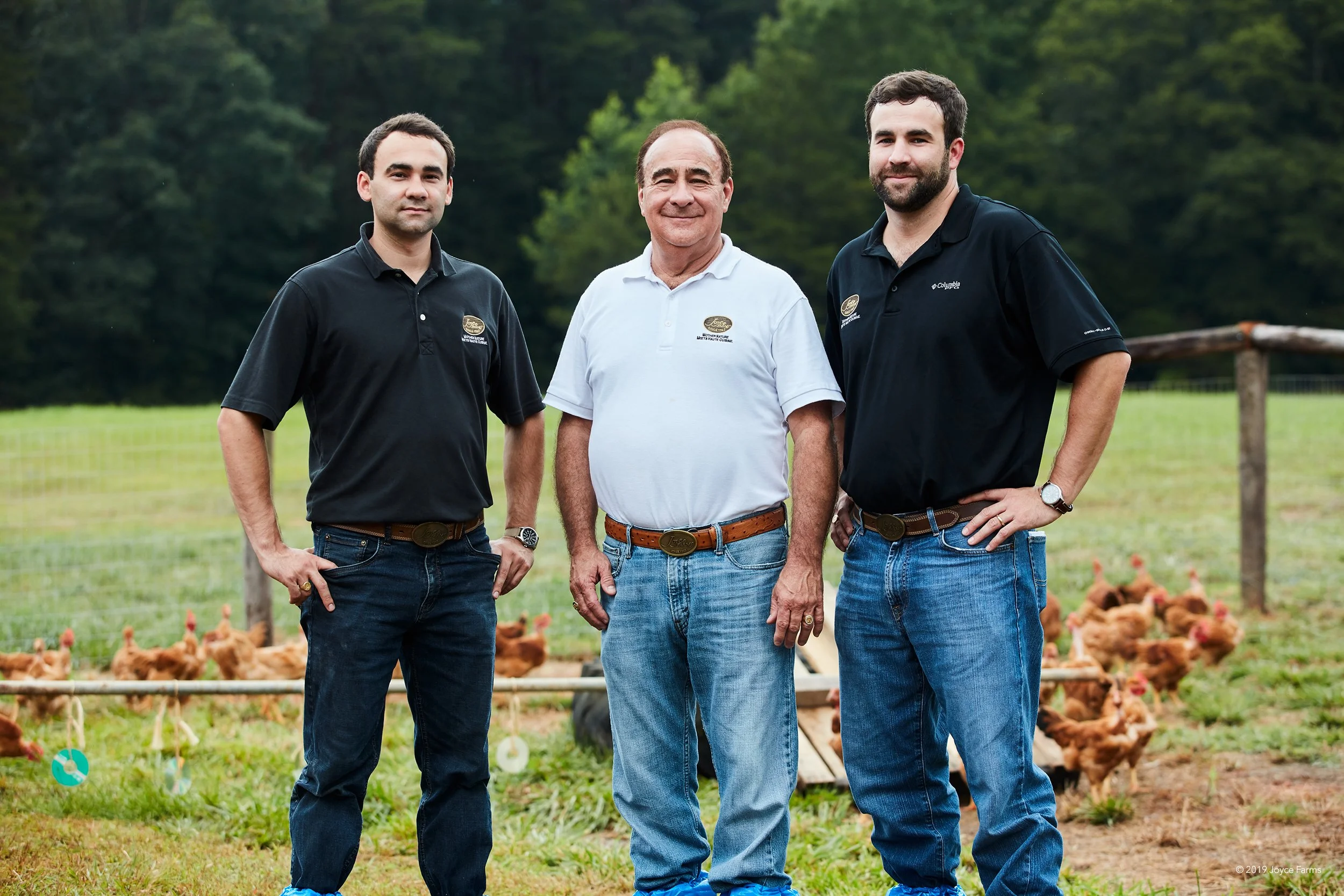 Alvin, Ryan, and Stuart Joyce standing in front of antibiotic-free, all-natural and heritage breed poultry at Joyce Farms, a family-owned business