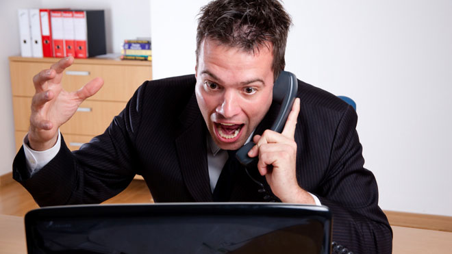 Man-Angry-at-Computer-on-Phone-in-Office.jpg