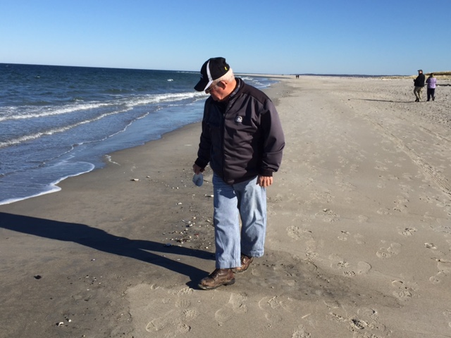 Dad picking up shells