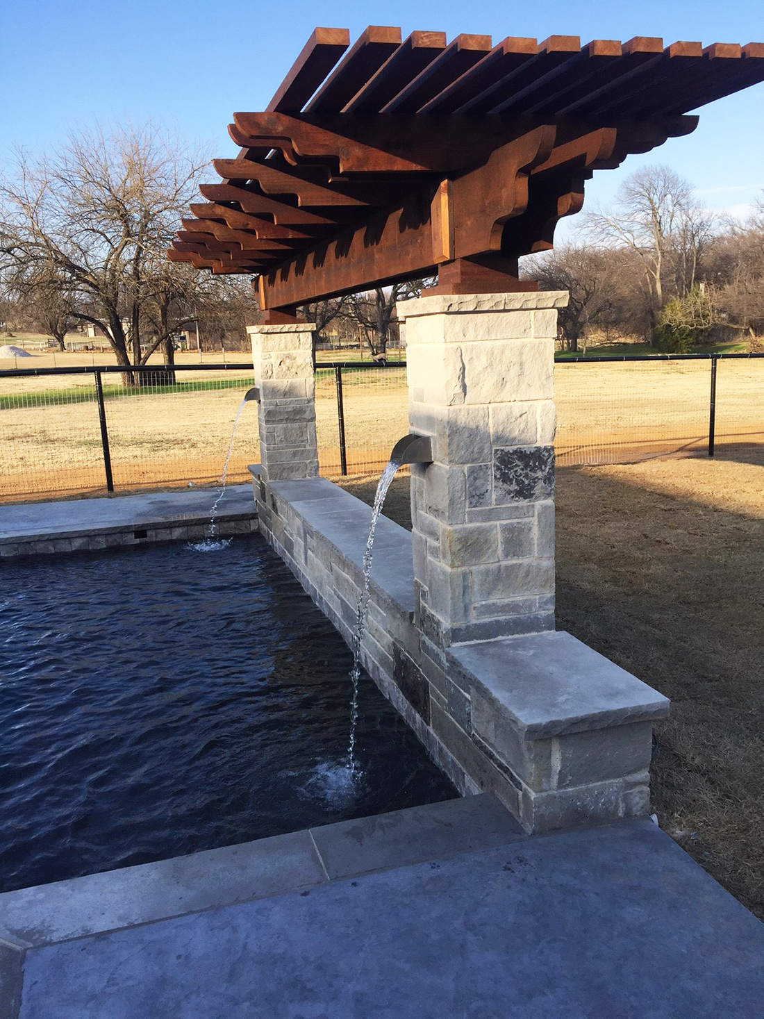BMR pool and patio waterfall stone covered pergola.jpg