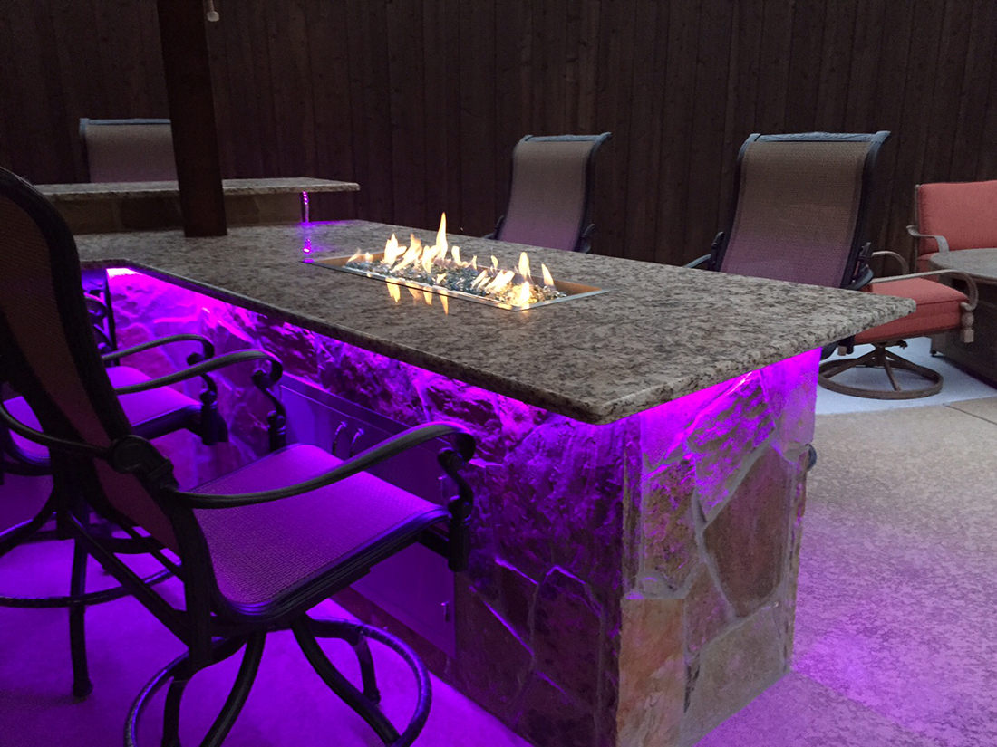 lit up fireplace bar bmr pool and patio.jpg