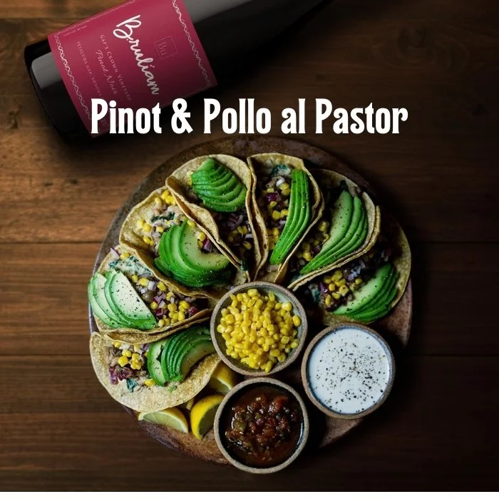 pinot noir bottle alongside tacos with sliced avocado