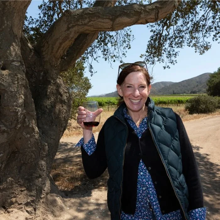 Kerith Overstreet of Bruliam Wines beside a tree in the Santa Lucia Highlands