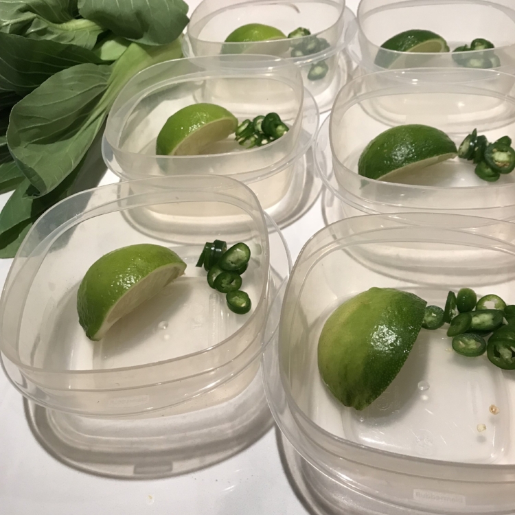 lime wedges and sliced serranos go into the container first