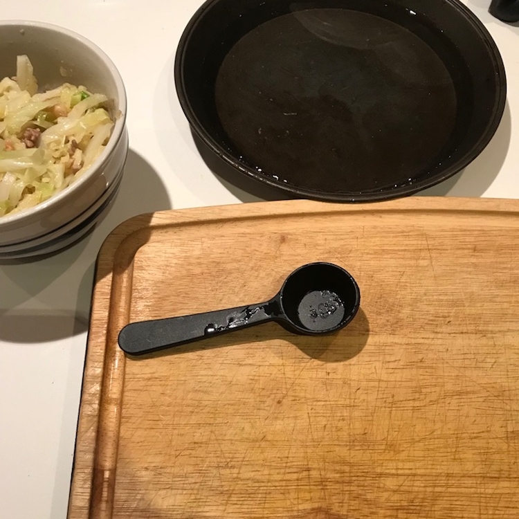 rolling station with hot water in a pan, measuring spoon for the filling, and a big ol' board for rolling