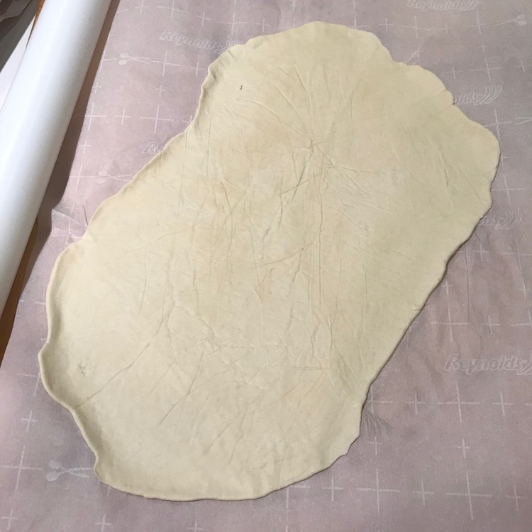 rolled out super thin between parchment sheets